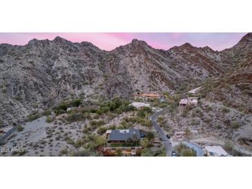 Panoramic aerial view of a hillside home with desert landscaping and mountain views at dusk at 1844 E Cinnabar Ave, Phoenix, AZ 85020