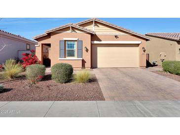 Charming single-story home with a well-manicured front yard and attached two-car garage at 19990 W Turney Ave, Litchfield Park, AZ 85340