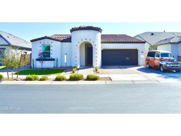 Charming single-story home featuring a turret entrance and a well-manicured front yard with unique decor at 22891 E Via Del Sol --, Queen Creek, AZ 85142