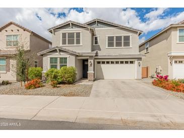 Charming two-story home with landscaped front yard, covered entry, and an attached two-car garage at 2460 E Athena Ave, Gilbert, AZ 85297