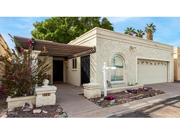 Charming single-story home featuring a stucco facade, mature trees, and a welcoming front porch at 2824 N 42Nd Way, Phoenix, AZ 85008