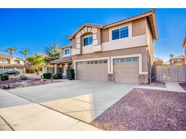 Two-story home featuring a three-car garage and low-maintenance desert landscaping at 2977 E Teakwood Pl, Chandler, AZ 85249