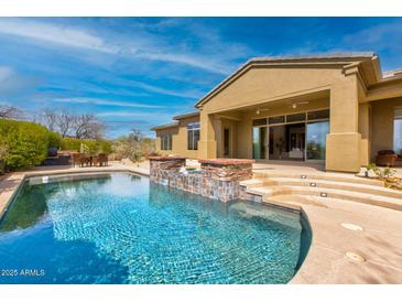 Stunning backyard showcasing a pool with spa, water feature, and patio, perfect for outdoor entertaining and relaxation at 37654 N 102Nd Pl, Scottsdale, AZ 85262
