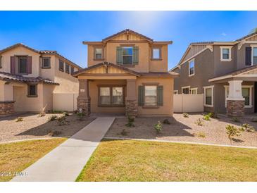 Charming two-story home with a well-maintained lawn and desert landscaping at 5828 E Hoover Ave, Mesa, AZ 85206