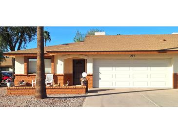 Charming single-story home with a well-manicured front yard, covered porch, and attached two-car garage at 8020 E Keats Ave # 271, Mesa, AZ 85209