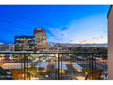 Balcony view overlooking the city skyline with distant mountains and bright city lights at dusk at 16 W Encanto Blvd # 616, Phoenix, AZ 85003
