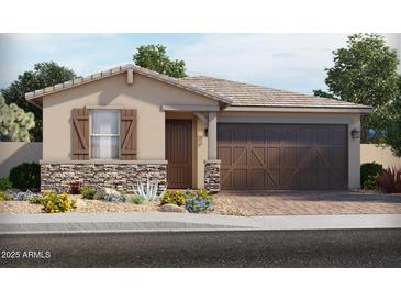 Charming single-story home boasts a two-car garage and stone accents, adding to its curb appeal at 17624 W Adams St, Goodyear, AZ 85338
