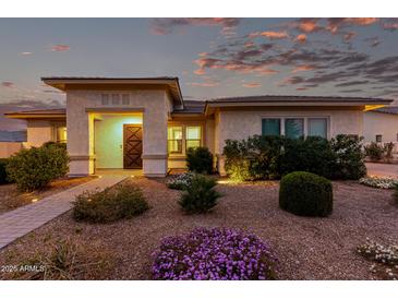 Inviting single-story home featuring a landscaped front yard with a decorative stone pathway, enhancing curb appeal at 23145 E Stonecrest Dr, Queen Creek, AZ 85142