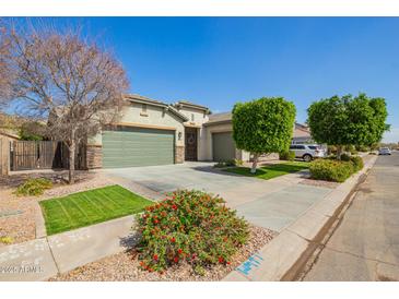 Charming single-story home with a well-manicured lawn, mature trees, and a spacious three car garage at 3556 E Ivanhoe St, Gilbert, AZ 85295