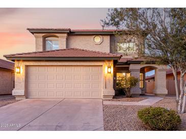 Charming two-story home featuring a neutral exterior, a two-car garage, and manicured landscaping at 4720 E Adobe Dr, Phoenix, AZ 85050