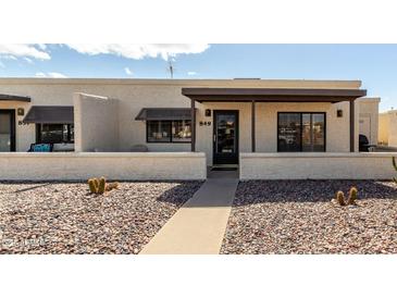 Charming townhome featuring a private entryway and desert landscaping at 849 E Lancaster Cir, Florence, AZ 85132