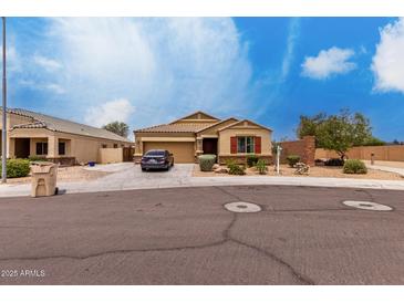 Charming single-story home with a desert-landscaped yard and a spacious driveway at 9302 W Georgia Ave, Glendale, AZ 85305