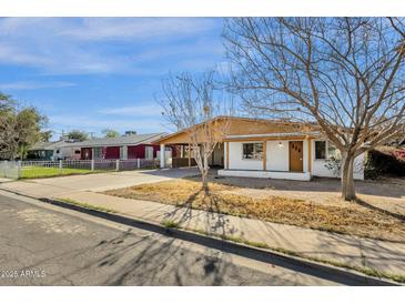 Charming single-story home with a carport and low-maintenance front yard at 104 S Doran --, Mesa, AZ 85204