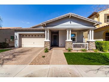 Charming single-story home with a welcoming front porch and well-maintained landscaping at 10532 E Palladium Dr, Mesa, AZ 85212