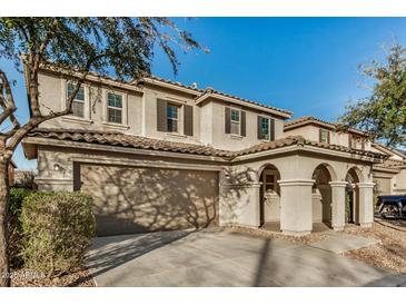 Charming two-story home featuring a neutral palette, covered entryway, two-car garage, and a classic tile roof at 11918 W Yearling Ct, Peoria, AZ 85383