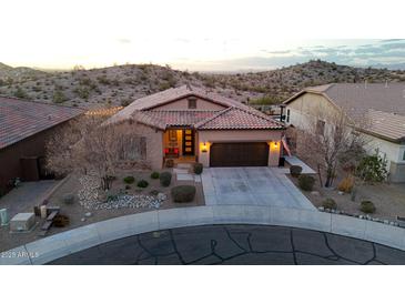 Exterior front view of a well-maintained home with a landscaped yard and three-car garage at 12008 S 186Th Dr, Goodyear, AZ 85338