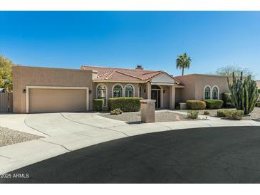 Charming, single-story home with a well maintained yard, three-car garage, and beautiful desert landscaping at 14401 N 60Th Pl, Scottsdale, AZ 85254