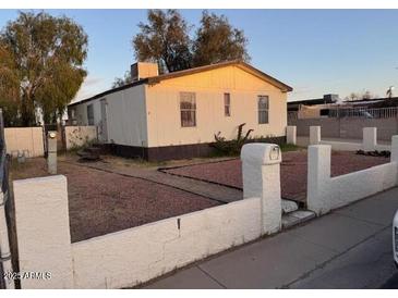 Single-story home with a fenced yard and desert landscaping at 16523 N Queen Esther Dr, Surprise, AZ 85378