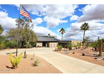 Stunning desert home with an American flag, gorgeous landscaping, and circular driveway at 16920 E Monterey Dr, Fountain Hills, AZ 85268