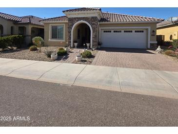 Charming single-story home features stone accents, a tiled roof and a two car garage at 24986 N 172Nd Ln, Surprise, AZ 85387