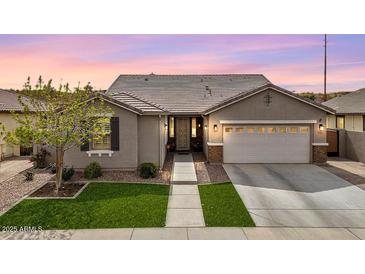 Inviting single-Gathering home with a well-manicured lawn and a two-car garage as viewed at dusk at 3121 N Loma Vista Dr, Mesa, AZ 85213