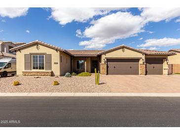 Charming home featuring desert landscaping and a spacious three car garage at 7630 E Knoll St, Mesa, AZ 85207