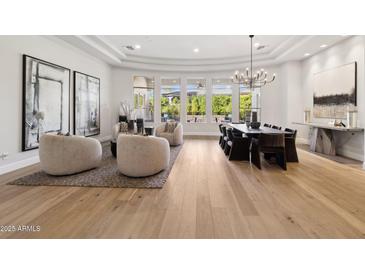 Open-concept living and dining area with abundant natural light and neutral designer finishes at 8832 E Wethersfield Rd, Scottsdale, AZ 85260