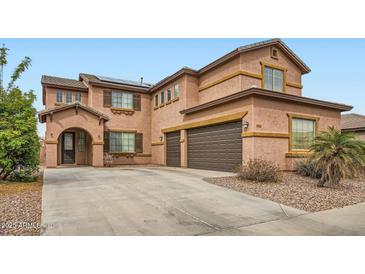 Charming two-story home featuring a three-car garage and desert landscaping at 14544 W Sierra St, Surprise, AZ 85379