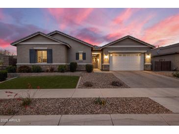 Charming single-story home with manicured lawn and a two-car garage at 20040 E Kestrel St, Queen Creek, AZ 85142
