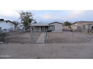 Charming single-story home with a secure chain-link fence and a low-maintenance yard at 3640 W Garfield St, Phoenix, AZ 85009