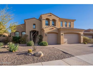 Stunning Southwestern home featuring a two-car garage, beautiful desert landscaping, and a neutral color palette at 3859 E Wood Dr, Chandler, AZ 85249