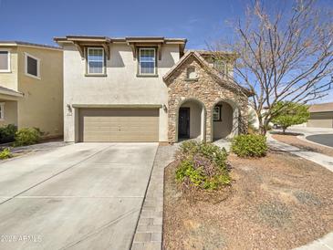 Charming two-story home with stone accents, a two-car garage, and a well-maintained front yard at 842 E Beverly Rd, Phoenix, AZ 85042