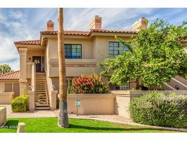 Charming two-story condo with a private entrance, lush landscaping, and a well-maintained exterior at 9711 E Mountain View Rd # 2524, Scottsdale, AZ 85258