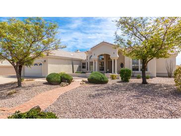 Inviting single-story home featuring manicured landscaping, a tile roof, and an arched entryway with stately columns at 15803 E Tumbleweed Dr, Fountain Hills, AZ 85268