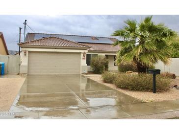 Charming single-story home featuring a two-car garage, desert landscaping and solar panels at 16243 N 27Th St, Phoenix, AZ 85032