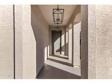 Welcoming front entrance with stylish light fixtures and neutral colored walls at 20745 N Verbena Ln, Maricopa, AZ 85138