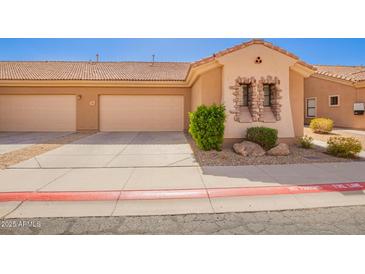 Charming home exterior featuring a three car garage, desert landscaping, and stone facade detailing at 2565 S Signal Butte Rd # 8, Mesa, AZ 85209