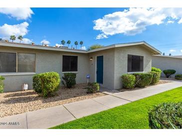 Charming single-story home with a tidy front yard, featuring lush green grass and trimmed shrubs at 3402 N 32Nd St # 116, Phoenix, AZ 85018