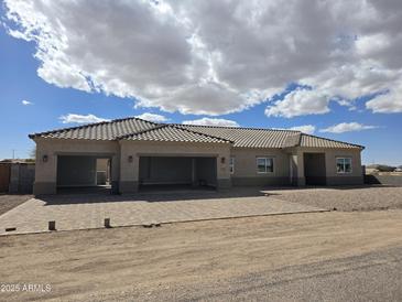 A stunning single-story home featuring a spacious three-car garage and a beautifully paved driveway at 3620 N Juniper Dr, Eloy, AZ 85131