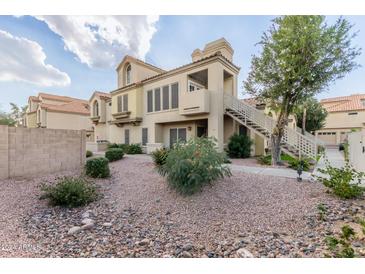 Beautiful two-story home featuring desert landscaping, stairway and charming architectural details at 7675 E Mcdonald Dr # 225, Scottsdale, AZ 85250