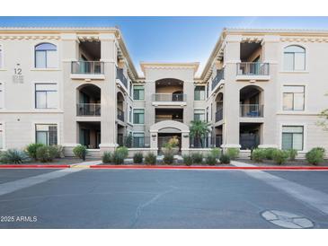 Apartment building exterior with balconies, arched entryways, and well-maintained landscaping at 11640 N Tatum Blvd # 3074, Phoenix, AZ 85028