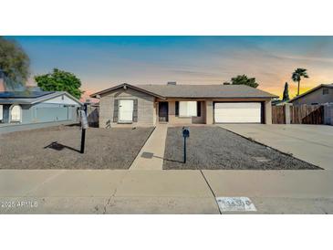 Charming single-story home with a well-maintained front yard and attached garage at 1430 W Rockwood Dr, Phoenix, AZ 85027