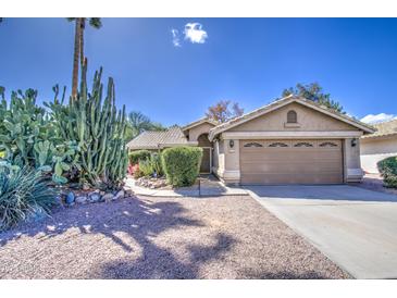 Charming single-story home featuring desert landscaping, a two-car garage, and a well-maintained front yard at 2560 S Rowen --, Mesa, AZ 85209