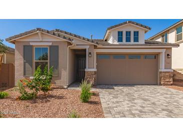 Charming single-Gathering home with stone accents, well-maintained landscaping, and a paved driveway at 5352 W Las Palmaritas Dr, Glendale, AZ 85302