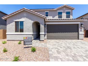 Charming two-story home featuring a neutral color palette, an attached two-car garage, and low maintenance desert landscaping at 11605 W Green Dr, Youngtown, AZ 85363