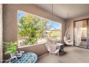 Relax on this peaceful patio with two hanging macrame chairs and beautiful views of the desert landscape at 15380 N 100Th St # 2098, Scottsdale, AZ 85260