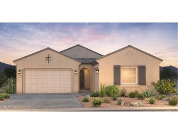 Inviting single-story home with neutral tones, a two-car garage, and desert landscaping, perfect for modern living at 16693 W Saguaro Park Ln, Surprise, AZ 85387