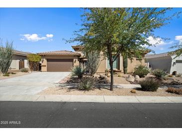 Charming single-story home featuring a desert-landscaped front yard, a driveway, and a two-car garage at 1708 W Dusty Wren Dr, Phoenix, AZ 85085