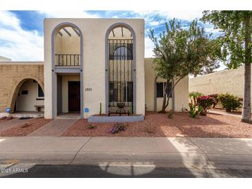 Charming home with unique architectural details and a well-maintained front yard at 1725 W Marlette Ave, Phoenix, AZ 85015