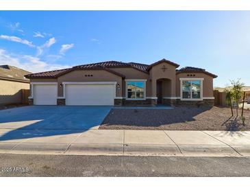 Charming single-story home with a three-car garage and desert landscaping at 17735 W Brown St, Waddell, AZ 85355